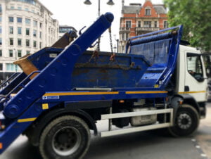 Image of Blue skip truck