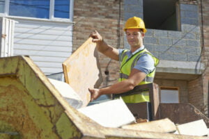 Image of builder and yellow skip