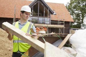 Builder placing waste in a skip