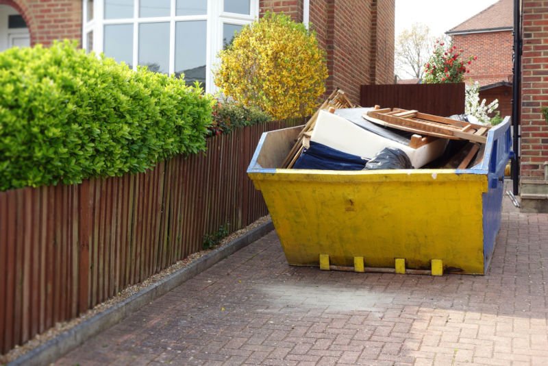 Yellow Skip on Driveway